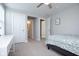 Bedroom with neutral tones, features a bed, a desk, and entryways to closet and bathroom at 5351 Rose Dr, Zionsville, IN 46077
