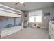 Bright bedroom featuring a bunk bed, a window, and a cozy seating area with comfortable armchairs at 5351 Rose Dr, Zionsville, IN 46077