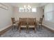 Bright dining room with a wooden table, six chairs, and stylish light fixture at 5351 Rose Dr, Zionsville, IN 46077