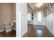 Hallway leads to a powder room and entryway in neutral tones at 5351 Rose Dr, Zionsville, IN 46077