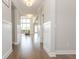 Hallway view to living room, featuring pristine trim and hardwood floors at 5351 Rose Dr, Zionsville, IN 46077