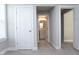 Hallway with white trim and neutral walls, includes a view into a bathroom at 5351 Rose Dr, Zionsville, IN 46077