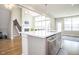 Bright kitchen features gray cabinets, stainless appliances, a large island, and an open floorplan at 5351 Rose Dr, Zionsville, IN 46077