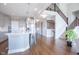 Bright kitchen features gray cabinets, stainless appliances, a large island, and an open floorplan at 5351 Rose Dr, Zionsville, IN 46077