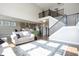 Spacious living room that flows into the kitchen area and features a staircase at 5351 Rose Dr, Zionsville, IN 46077