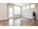 Bright living room features hardwood floors, large windows, and a door leading to the backyard at 5351 Rose Dr, Zionsville, IN 46077