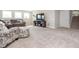 Spacious living room featuring plush carpeting, comfortable seating, and a modern entertainment center at 5351 Rose Dr, Zionsville, IN 46077