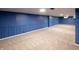 Finished basement featuring blue paneled walls and neutral carpet flooring at 5803 Schoolwood Dr, Speedway, IN 46224
