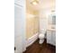 Full bathroom featuring a tub with sliding glass doors, a single sink vanity, and wood-look floors at 5803 Schoolwood Dr, Speedway, IN 46224