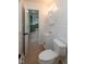 Hall bathroom featuring a white vanity, medicine cabinet, and toilet, all with modern fixtures at 5803 Schoolwood Dr, Speedway, IN 46224
