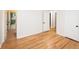 Bedroom featuring neutral paint, hardwood floors, and access to a bathroom and hallway at 5803 Schoolwood Dr, Speedway, IN 46224