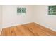 Bedroom featuring hardwood floors, diamond pane windows, and natural light at 5803 Schoolwood Dr, Speedway, IN 46224