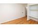 Bright bedroom featuring hardwood floors, an open closet with shelving, and neutral walls at 5803 Schoolwood Dr, Speedway, IN 46224