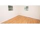 Cozy bedroom with hardwood flooring, two windows, and neutral walls for versatile decor at 5803 Schoolwood Dr, Speedway, IN 46224