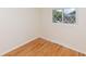 Cozy bedroom with wood floors, diamond pane window, and natural light at 5803 Schoolwood Dr, Speedway, IN 46224