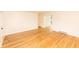Bright living room with gleaming hardwood floors, neutral walls, and access to other rooms at 5803 Schoolwood Dr, Speedway, IN 46224