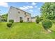 Expansive backyard with lush green grass, mature trees, and a relaxing swing set, perfect for outdoor activities at 6045 Copeland Mills Ct, Indianapolis, IN 46221