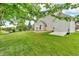 Scenic backyard with mature trees, a charming shed, and plenty of space for outdoor gatherings and recreation at 6045 Copeland Mills Ct, Indianapolis, IN 46221