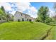 Lush backyard with a stream and mature trees creates a private and serene outdoor living space at 6045 Copeland Mills Ct, Indianapolis, IN 46221