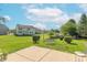 Expansive backyard featuring a swing set, pond, and a view of the home at 6045 Copeland Mills Ct, Indianapolis, IN 46221