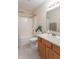 Bathroom featuring a shower-tub combo and a wooden vanity at 6045 Copeland Mills Ct, Indianapolis, IN 46221