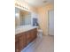 Bathroom with a modern vanity, bright lighting, and a separate toilet room at 6045 Copeland Mills Ct, Indianapolis, IN 46221