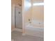 Bright bathroom featuring a shower, tub, and light-colored walls at 6045 Copeland Mills Ct, Indianapolis, IN 46221