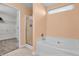This primary bathroom features a soaking tub, tiled floors and walk-in shower at 6045 Copeland Mills Ct, Indianapolis, IN 46221