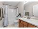 This full bathroom has a shower and tub and features a wood vanity at 6045 Copeland Mills Ct, Indianapolis, IN 46221