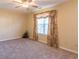 Bedroom features neutral carpet, window with drapery and ample natural light at 6045 Copeland Mills Ct, Indianapolis, IN 46221