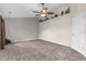 Large bedroom featuring neutral walls and carpeting, bright windows, and a ceiling fan at 6045 Copeland Mills Ct, Indianapolis, IN 46221
