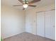 Bedroom with carpet, a ceiling fan, and double closets at 6045 Copeland Mills Ct, Indianapolis, IN 46221