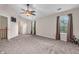 Large bedroom featuring neutral walls and carpeting, bright windows, and a ceiling fan at 6045 Copeland Mills Ct, Indianapolis, IN 46221