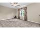 Comfortable bedroom featuring a ceiling fan and large window at 6045 Copeland Mills Ct, Indianapolis, IN 46221