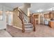 Inviting entryway with staircase and tile flooring leads to the open-concept kitchen and living areas at 6045 Copeland Mills Ct, Indianapolis, IN 46221
