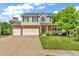 Charming two-story home with brick accents, green shutters, and a well-manicured lawn at 6045 Copeland Mills Ct, Indianapolis, IN 46221