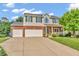 Inviting two-story home with a three-car garage, well-manicured lawn, and charming curb appeal at 6045 Copeland Mills Ct, Indianapolis, IN 46221