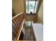 Upstairs view of the foyer, showing the front door, large window, and hardwood railing at 6045 Copeland Mills Ct, Indianapolis, IN 46221