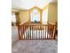 Foyer with hardwood railing overlooking the front door and large window, creating an inviting entrance at 6045 Copeland Mills Ct, Indianapolis, IN 46221
