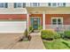 Close-up of front porch with brick siding and a decorative wreath on the teal front door at 6045 Copeland Mills Ct, Indianapolis, IN 46221