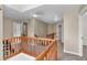 Second floor hallway with neutral colors and wooden railing at 6045 Copeland Mills Ct, Indianapolis, IN 46221