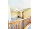 Hallway with neutral carpet, railing and an arched window providing natural light at 6045 Copeland Mills Ct, Indianapolis, IN 46221