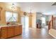 Open eat-in kitchen area with tile floors, wood cabinets, and natural light from the sliding glass door at 6045 Copeland Mills Ct, Indianapolis, IN 46221