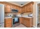 Close up shot of the kitchen featuring stainless steel appliances, wooden cabinets, and ample counter space at 6045 Copeland Mills Ct, Indianapolis, IN 46221
