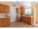 Kitchen showcasing neutral countertops, stainless steel dishwasher and sink, and ample cabinet space at 6045 Copeland Mills Ct, Indianapolis, IN 46221