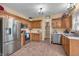 Well-equipped kitchen features stainless steel appliances, wooden cabinets, and tiled flooring at 6045 Copeland Mills Ct, Indianapolis, IN 46221