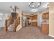 Spacious kitchen with stainless steel appliances, tile floors, and staircase to upper level at 6045 Copeland Mills Ct, Indianapolis, IN 46221