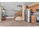 Kitchen with stainless steel refrigerator, wooden cabinets, and tile flooring leading to living area with staircase at 6045 Copeland Mills Ct, Indianapolis, IN 46221