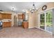 Kitchen area with tile flooring, wooden cabinets, stainless steel appliances, and a sliding glass door to the patio at 6045 Copeland Mills Ct, Indianapolis, IN 46221