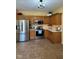 Traditional kitchen features stainless steel appliances, light countertops and oak cabinets at 6045 Copeland Mills Ct, Indianapolis, IN 46221